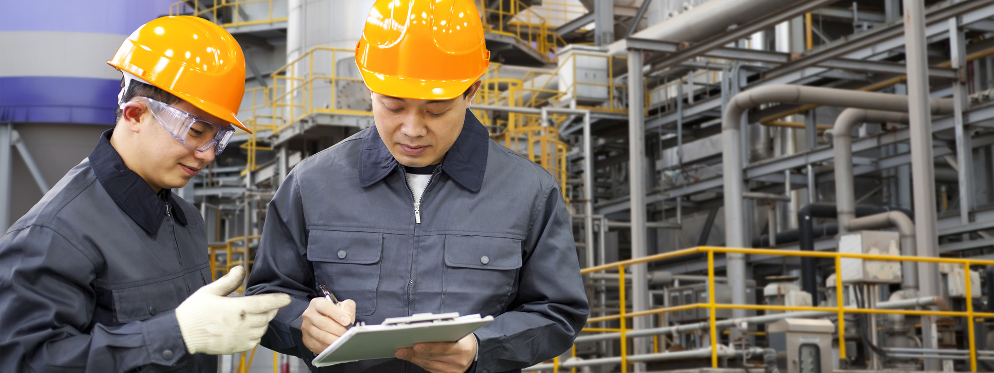 man in hard hat writing something